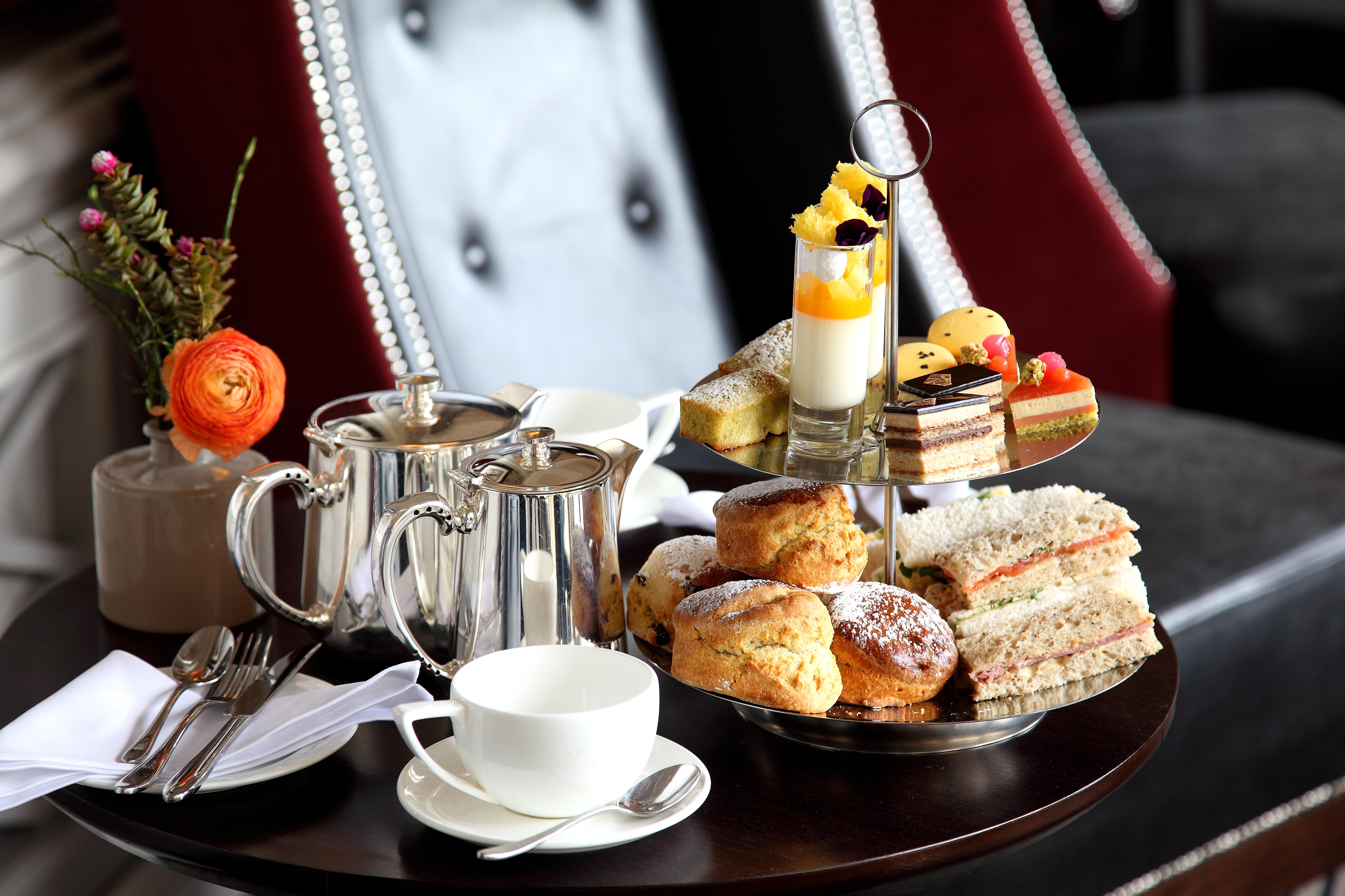 Macdonald Bath Spa Hotel Exterior foto The photo depicts an elegantly arranged afternoon tea setting. There is a tiered stand filled with a variety of treats, including scones, sandwiches, and small desserts like cakes and pastries. Accompanying this is a teapot and a cup on the table, su